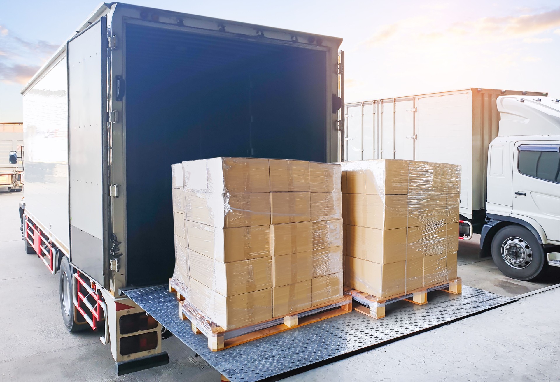 Bulk of Package Boxes Loading into Delivery Truck. Forklift Pallet Jack. Container Shipping. Supply Chain, Supplies Shipment Goods, Distribution. Freight Truck Logistics Cargo Transportation.